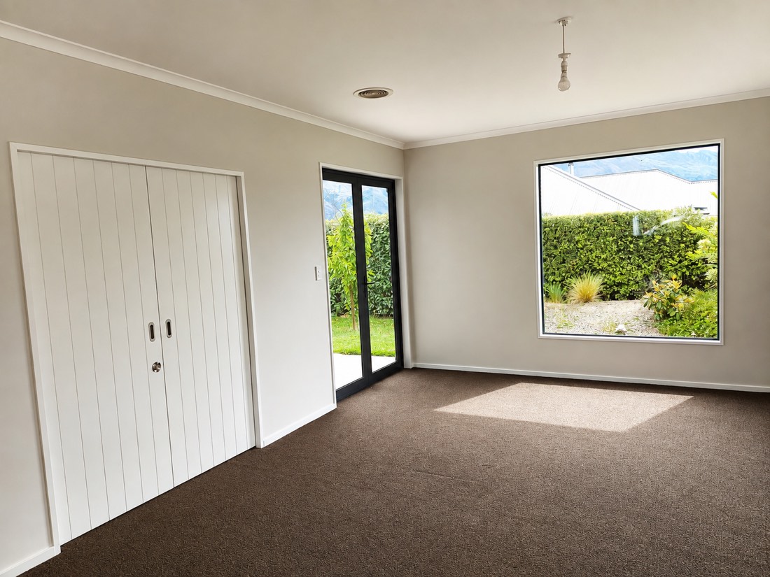 Repainted lounge in soft neutrals with fresh white doors and trim